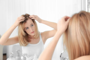 a woman looking at her hair